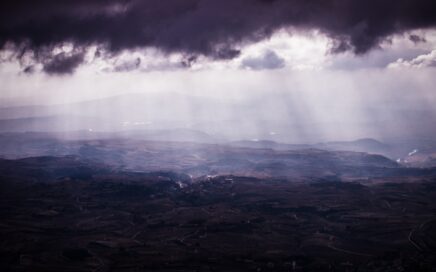 aerial view photography of mountain under cloudy sky