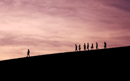 silhouette of people on hill