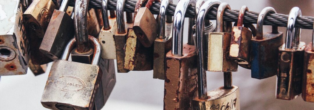 shallow focus photography of padlocks in steel cable