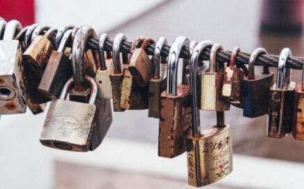 shallow focus photography of padlocks in steel cable