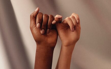 persons hand with white manicure