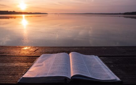 book on top of table and body of water