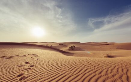 gray sand under white and blue sky