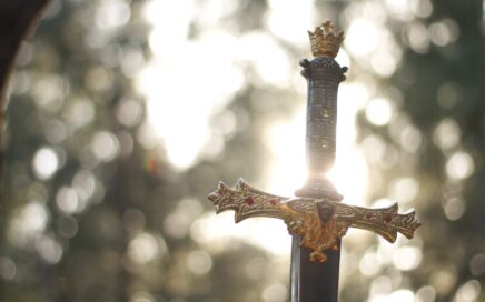 close-up photography of gold-colored and black sword