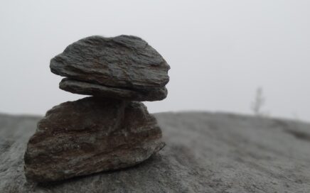 closeup photo of two gray stones on sand