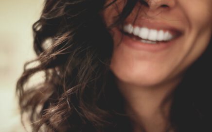 long black haired woman smiling close-up photography