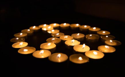 white candles on black surface