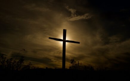 brown wooden cross under cloudy sky during daytime