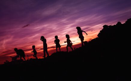 silhouette of children's running on hill