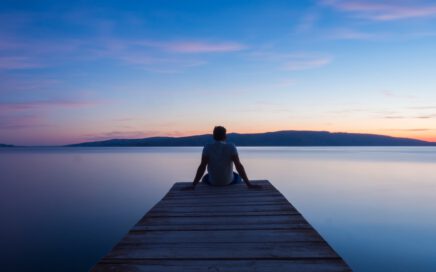 man siting on wooden dock