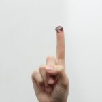 person showing right middle finger