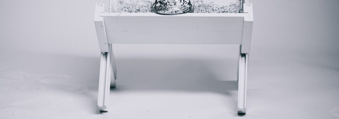 grayscale photography of tiara on table