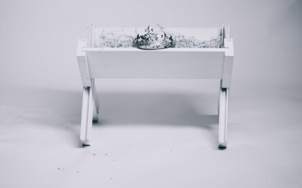 grayscale photography of tiara on table