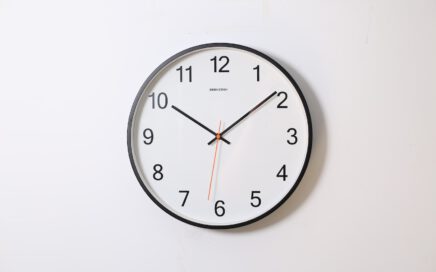 round analog wall clock pointing at 10:09
