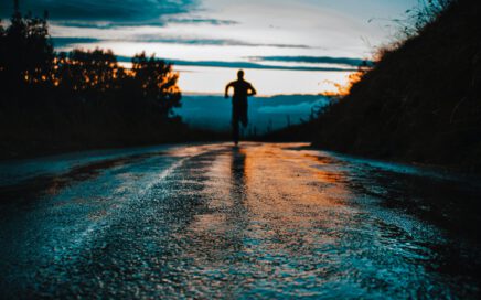 silhouette photo of a person running on road