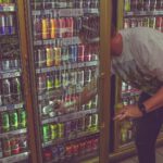 man getting can in beverage cooler