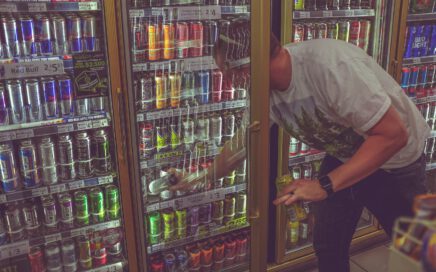 man getting can in beverage cooler