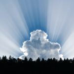 photography of clouds and forest trees