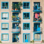 white and blue concrete 4-storey building