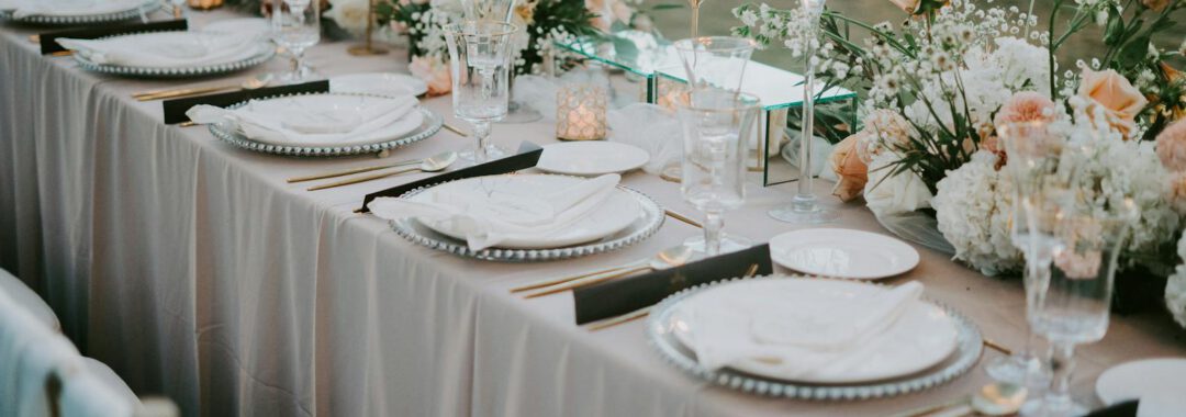 Beautifully decorated wedding reception table with floral arrangements and elegant tableware.